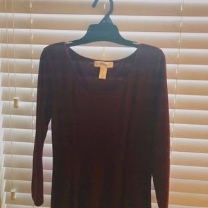 A maroon, long sleeved dress.
